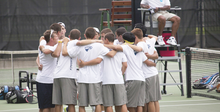 Courtesy of Emory Athletics The men's tennis team huddles together during a match. The No. 4 ranked squad defeated Georgia Perimeter College 9-0 in its last match of the season last weekend.