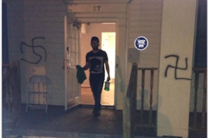 College sophomore Jake Mor is pictured trying to remove swastikas that were spray painted on the Alpha Epsilon Pi (AEPi) fraternity house on Sunday morning. Photo Courtesy of Emory AEPi.